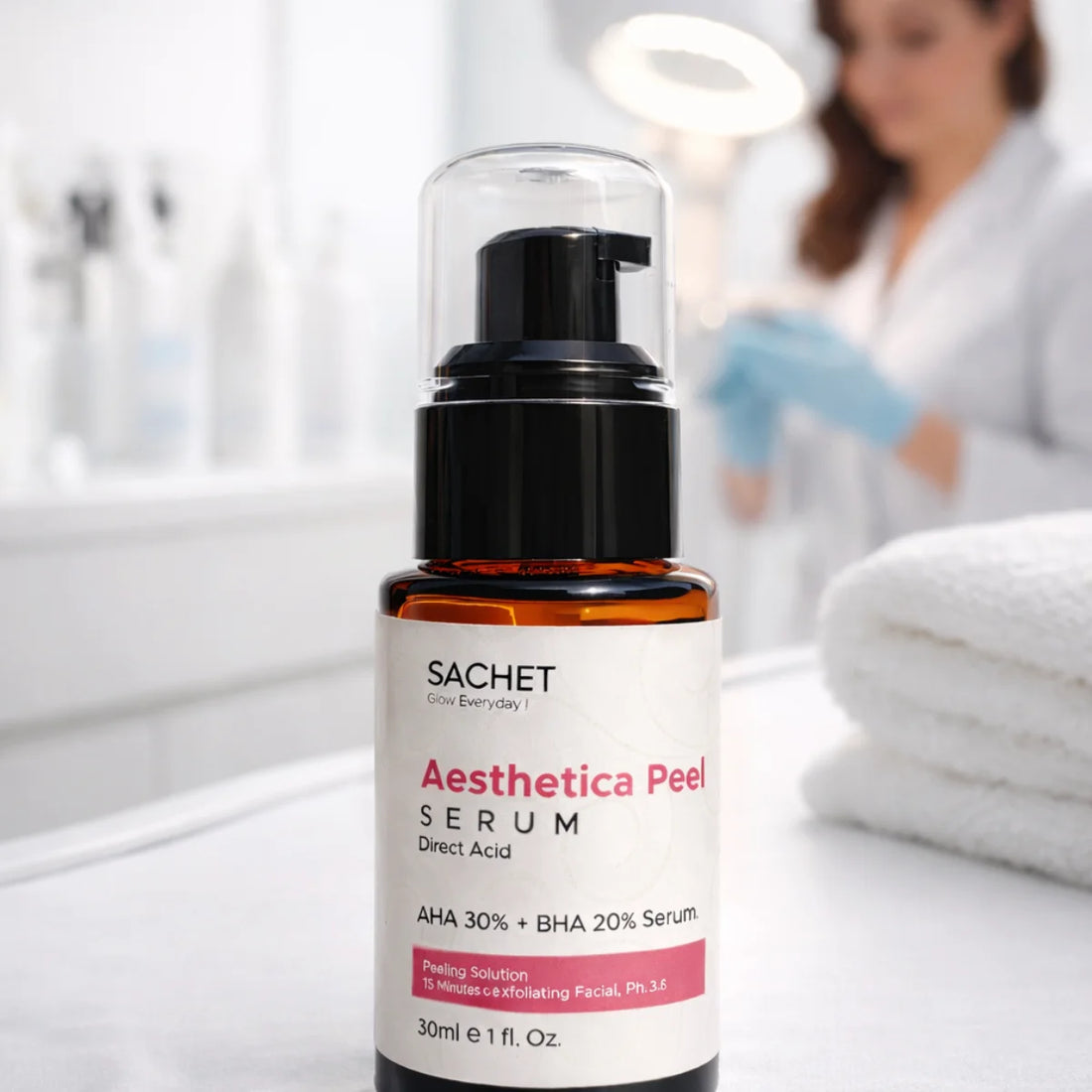 SACHET Aesthetica Peel Serum bottle on a white surface with a blurred background of a person in a lab coat.