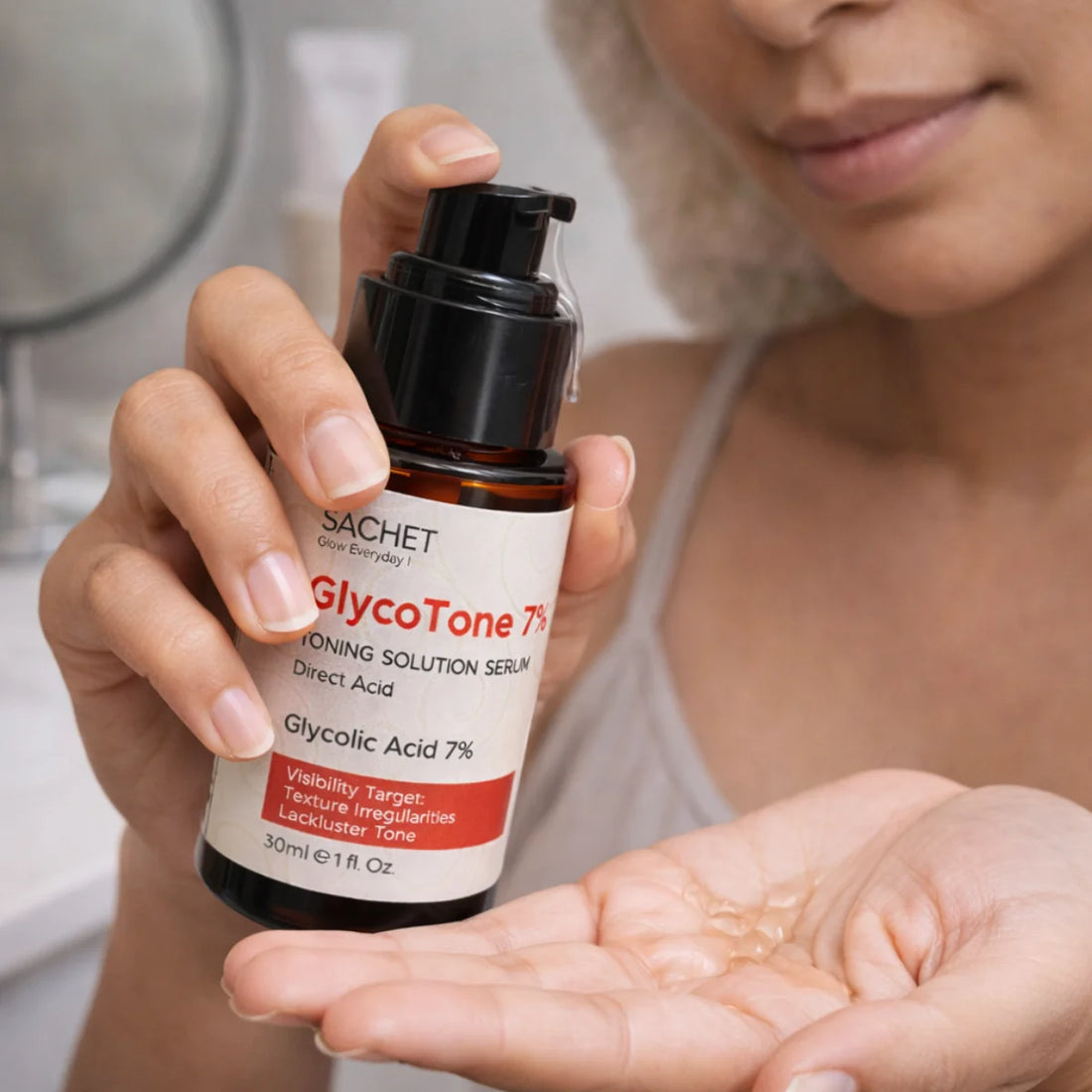 Person holding a bottle of GlycoTone 7% serum with a blurred background
