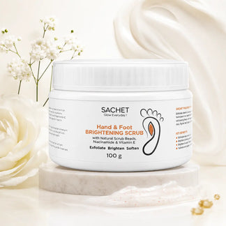 Sachet Hand & Foot Brightening Scrub jar with oranges and aloe vera on a beige background