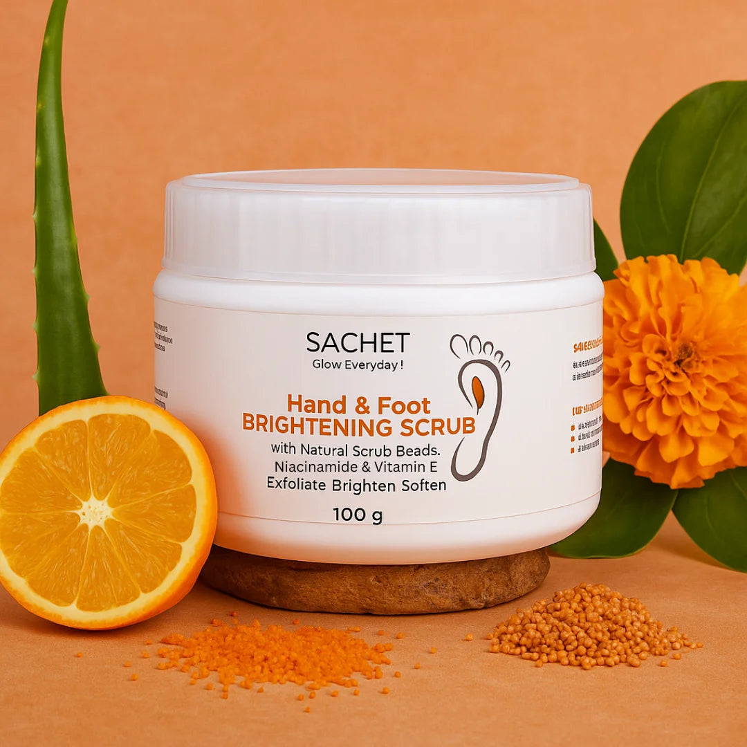 SACHET Hand & Foot Brightening Scrub jar with orange, aloe vera, and marigold flower on an orange background