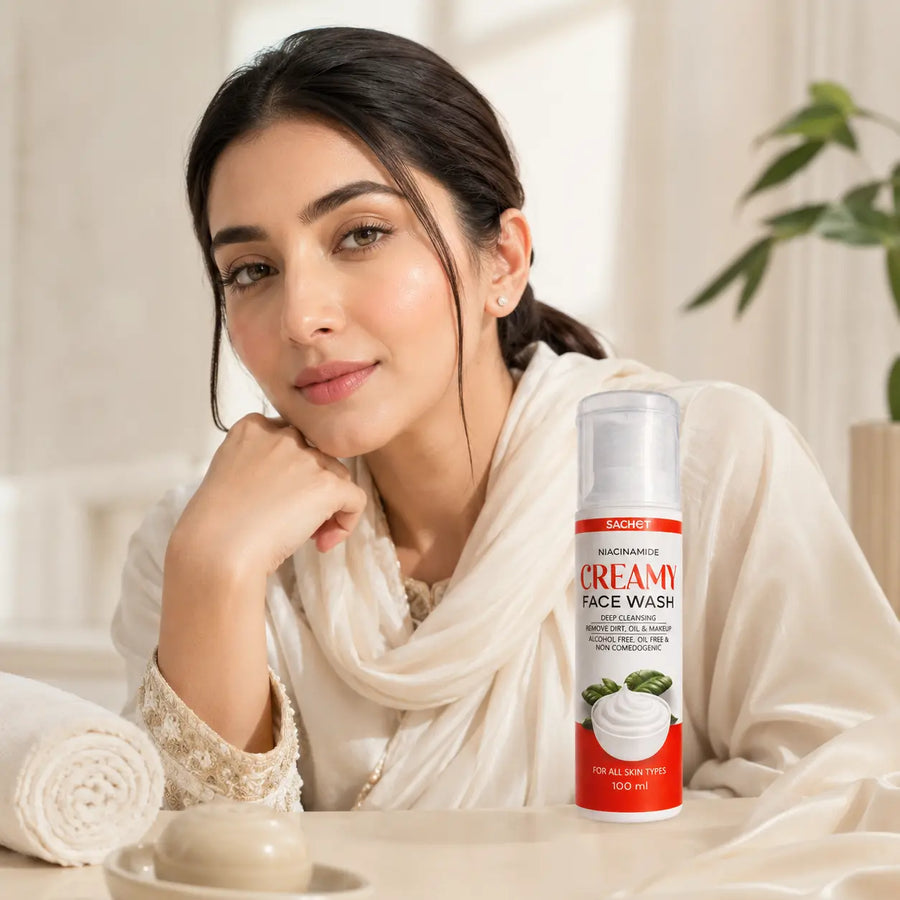 Woman holding a bottle of Sachet Niacinamide Face Wash with product details on a blurred background