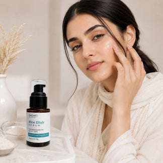 Hand holding a bottle of rice elixir serum with product details and customer feedback on a beige background