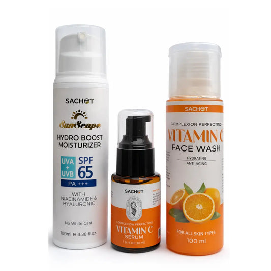Vitamin C skincare kit with bottles and oranges on a beige background